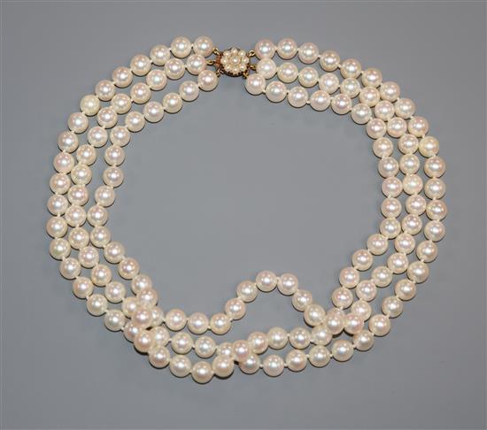 A triple strand cultured pearl choker necklace with yellow metal and cultured pearl set clasp, 36cm.